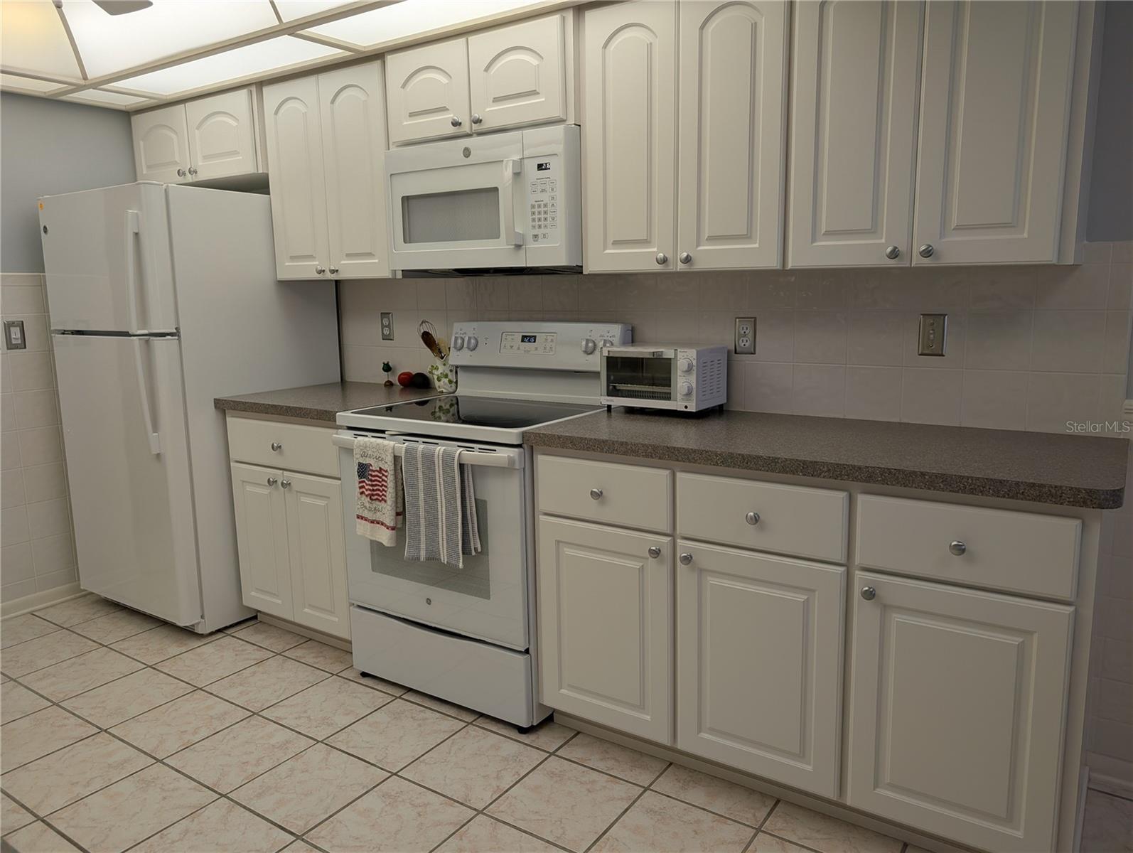 Ample countertop workspace and cabinetry for storage.