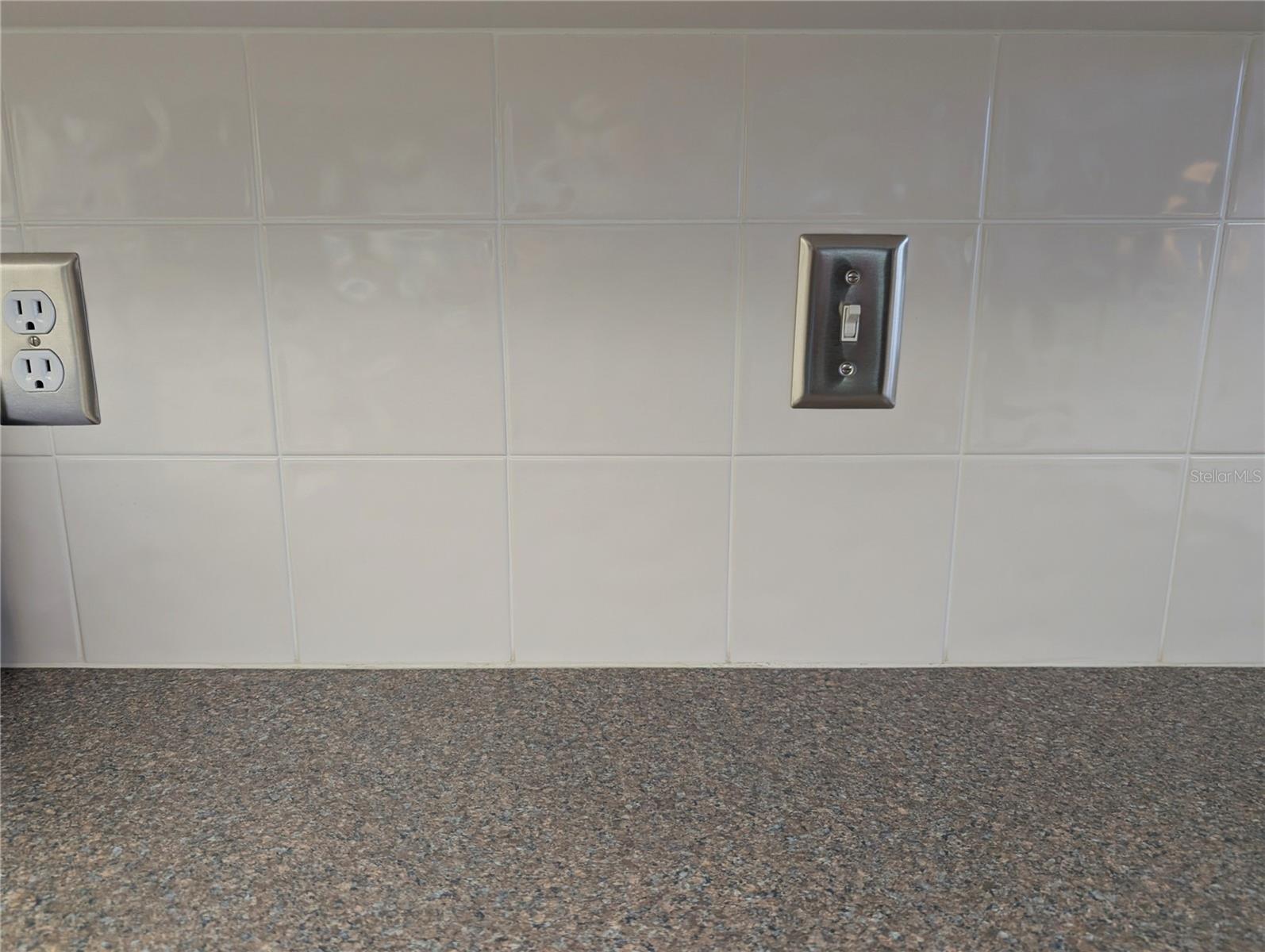 Closeup view of tile backsplash.