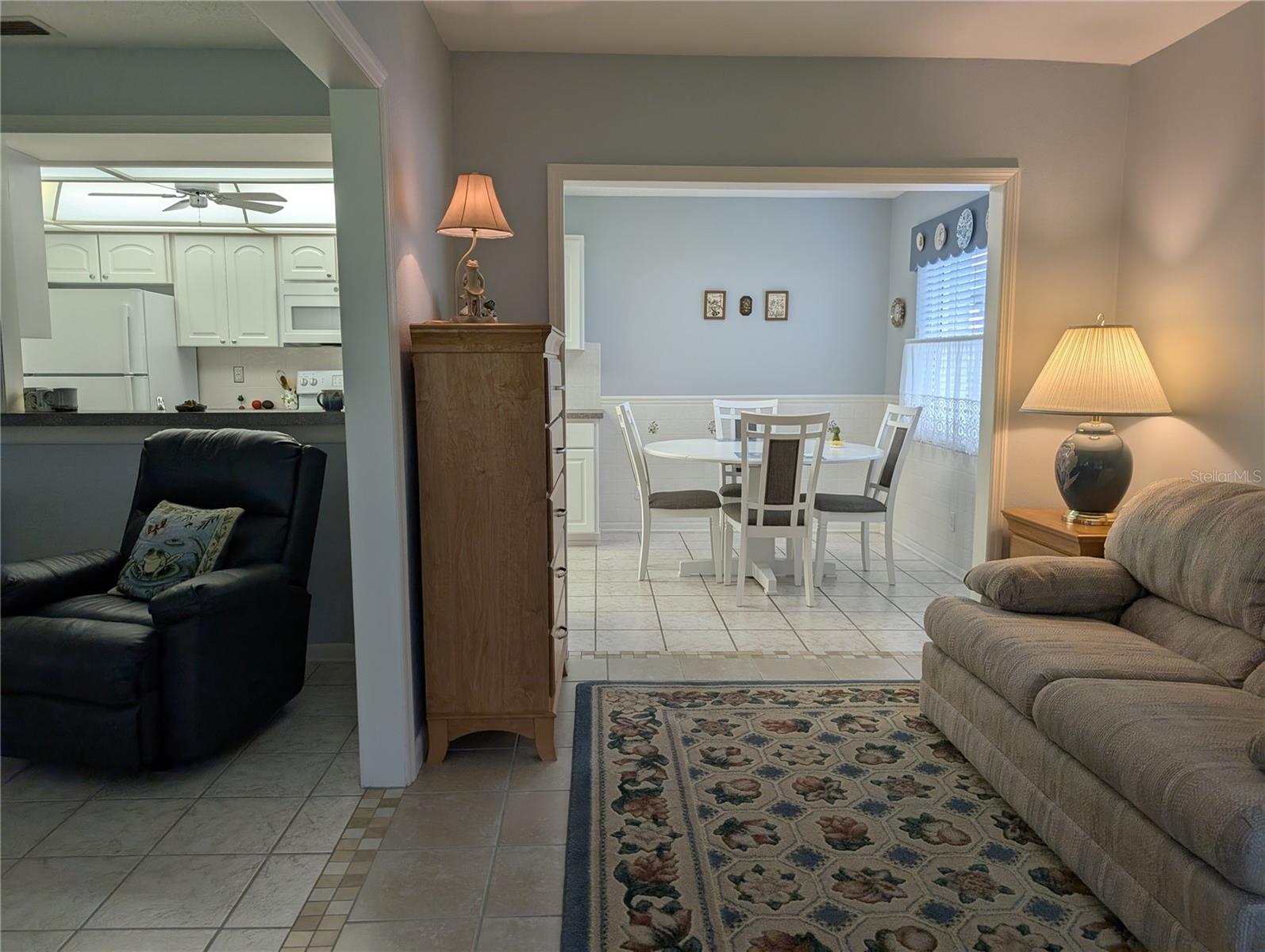 View from bonus room into eat in dinette on right and Florida room (kitchen seen behind) on left.