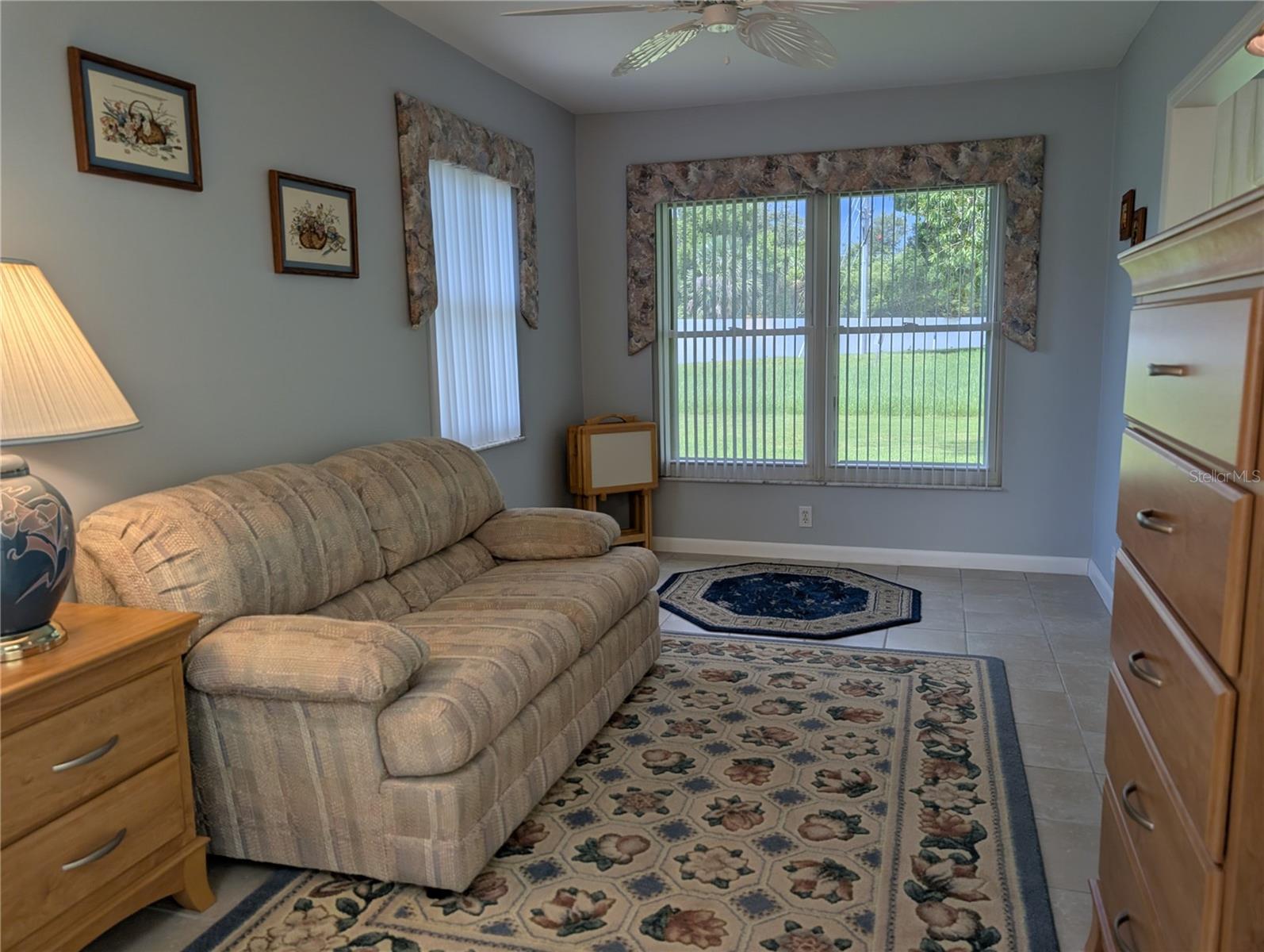 Renovated Bonus room features raised tile floor, updated ceiling fan, vertical blinds with valance and a great view. Florida room entrance is to the right.