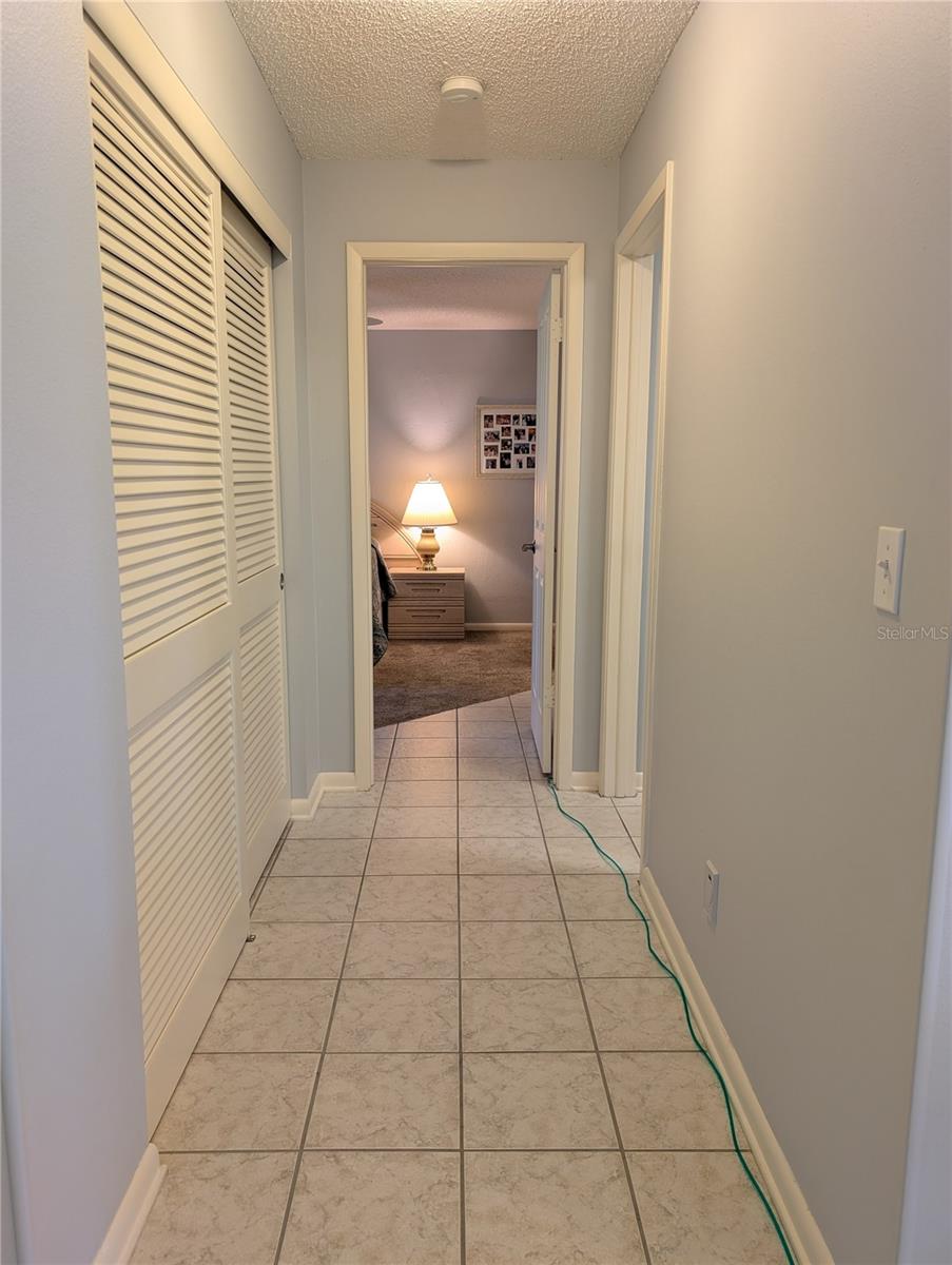View of hallway to Primary Bedroom w/ensuite bathroom.  Closet on left, Office to right.