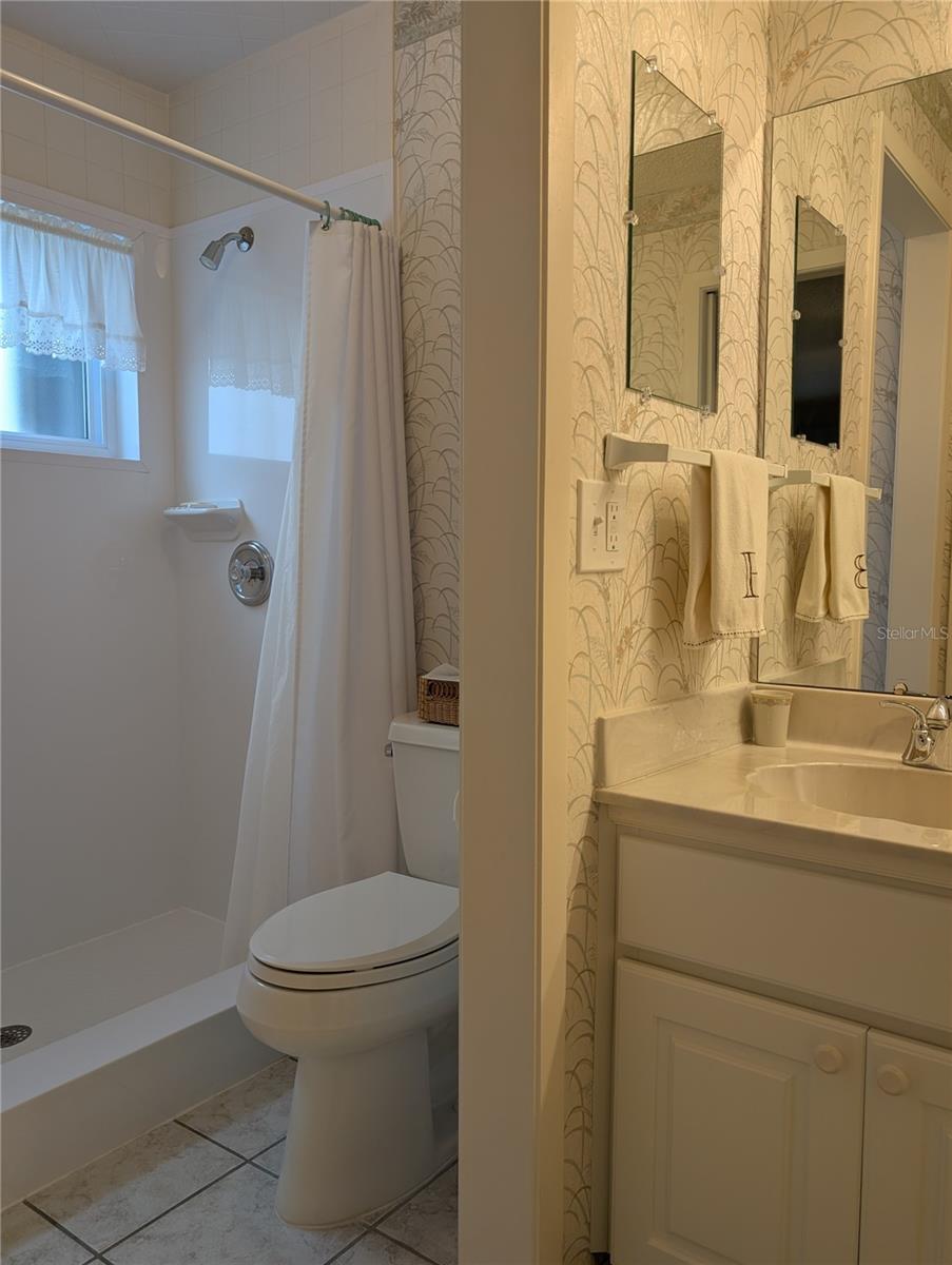 Wet room updates include a ceiling vent, comfort height commode and a Bath Fitters walk in shower (2006).