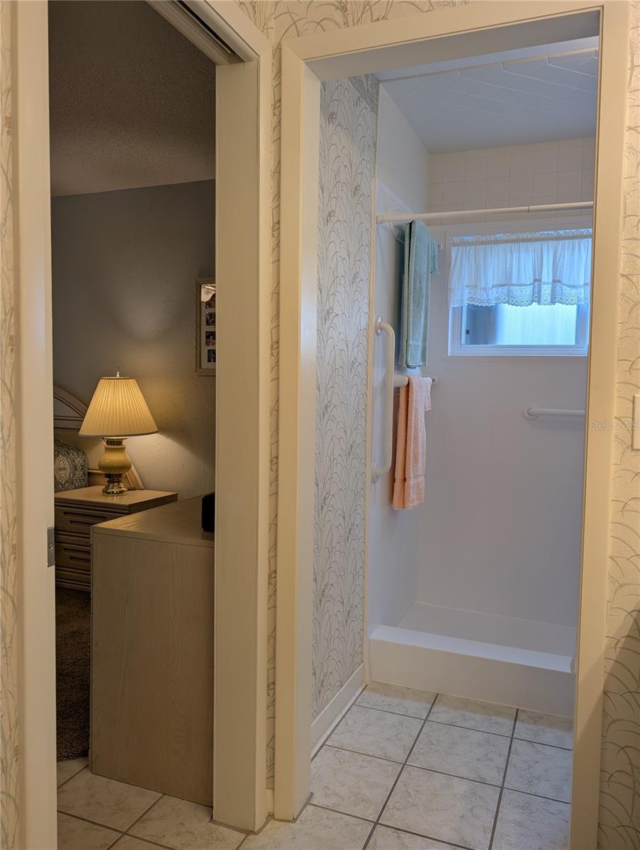View into primary bedroom from bathroom.