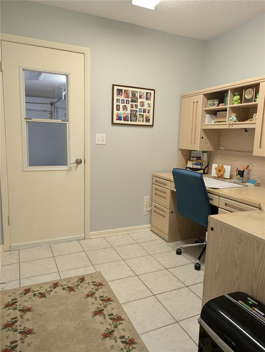 View into office from hallway. Office has direct access to garage.
