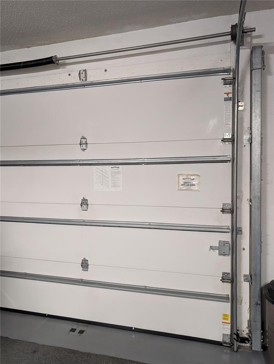 Reinforcement bracket stored on right side of garage door.