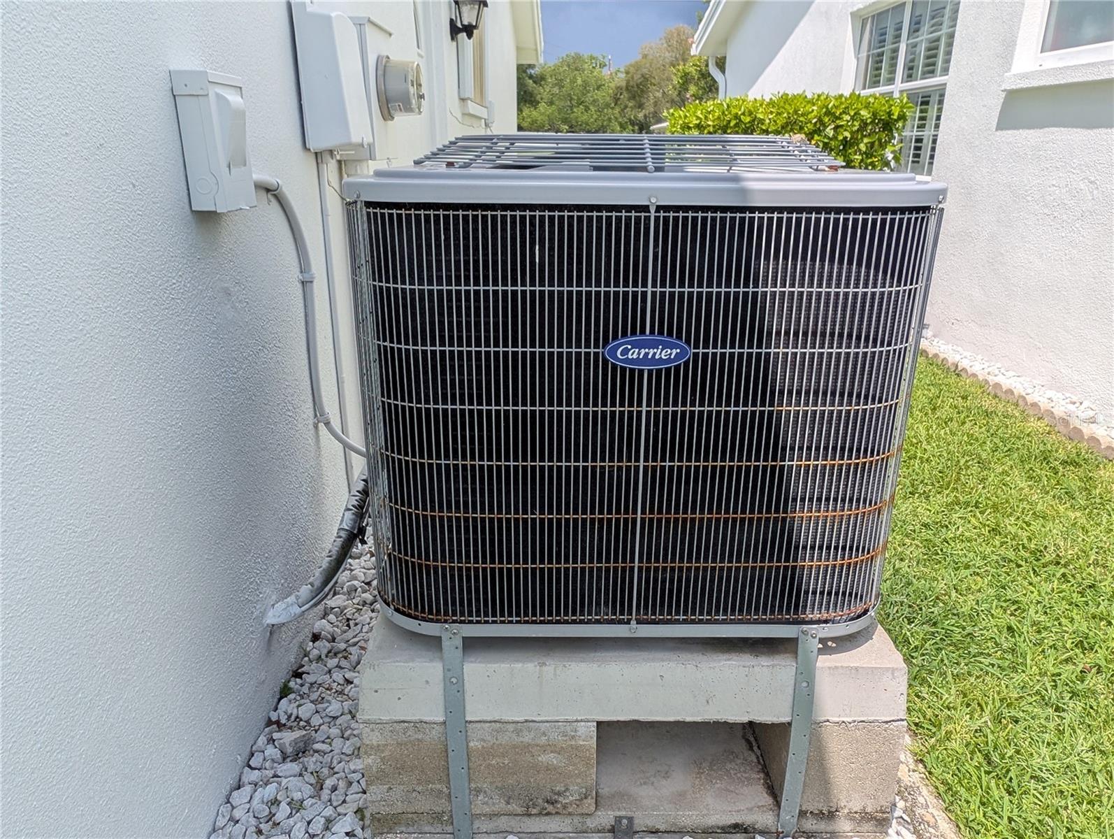 Carrier HVAC service inspection twice a year (last service call 2/2026). Decorative stone installed around house perimeter serves as decorative landscaping and protection for stucco walls.