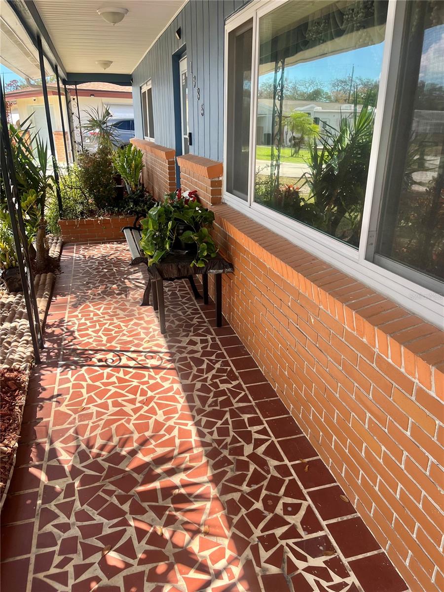 Welcoming Front Porch with Pristine condition Mid-Century "Broken Tile" flooring.