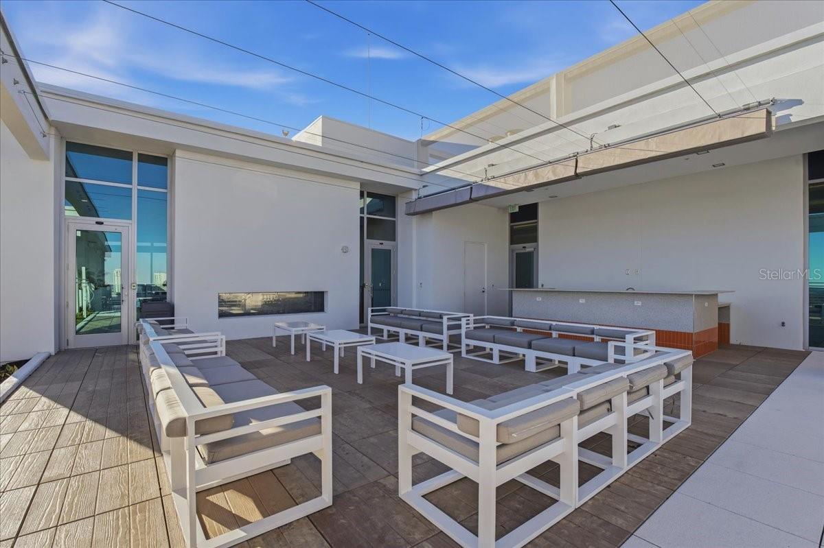 COMMUNITY ROOFTOP SITTING AREA WHICH HAS A REMOTE CONTROL AWNING FOR SHADE