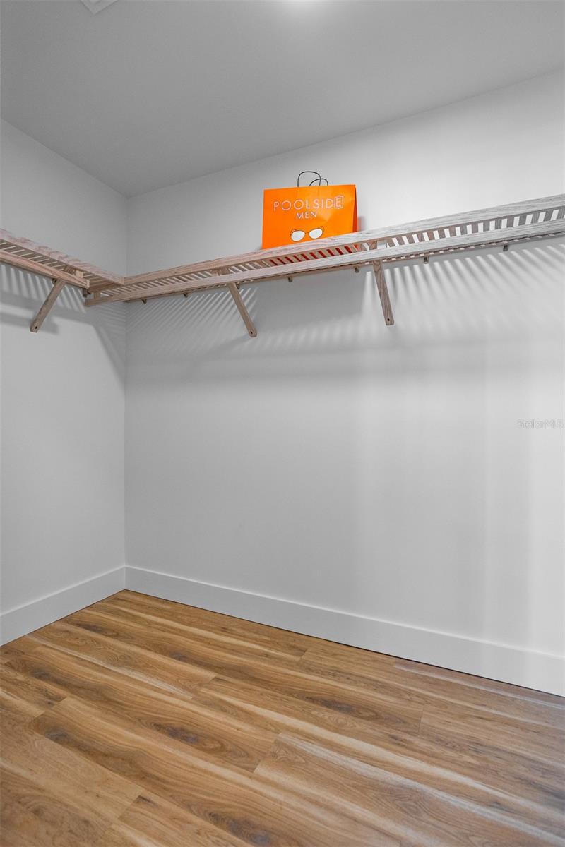 Spacious primary walk-in closet for convenience and luxury