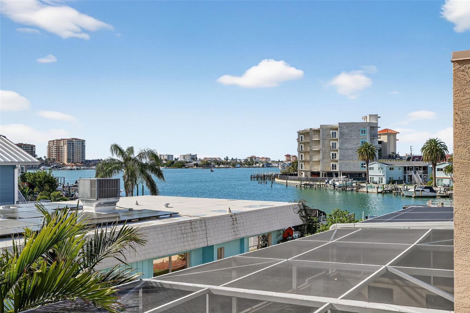 The spacious Primary bedroom is a sanctuay with a wood burning fireplace, hardwood flooring, double walk in closets, and private balcony.