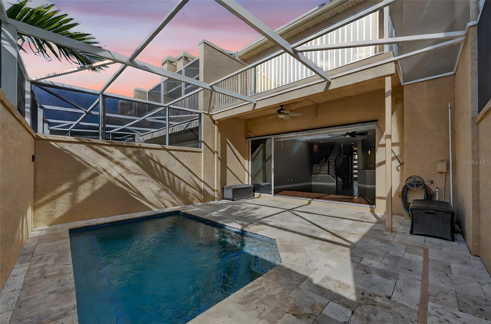 The Famlily Great room has a wood burnint fireplace and doors that open completely out to you enclosed screened pool area for great indoor outdoor living