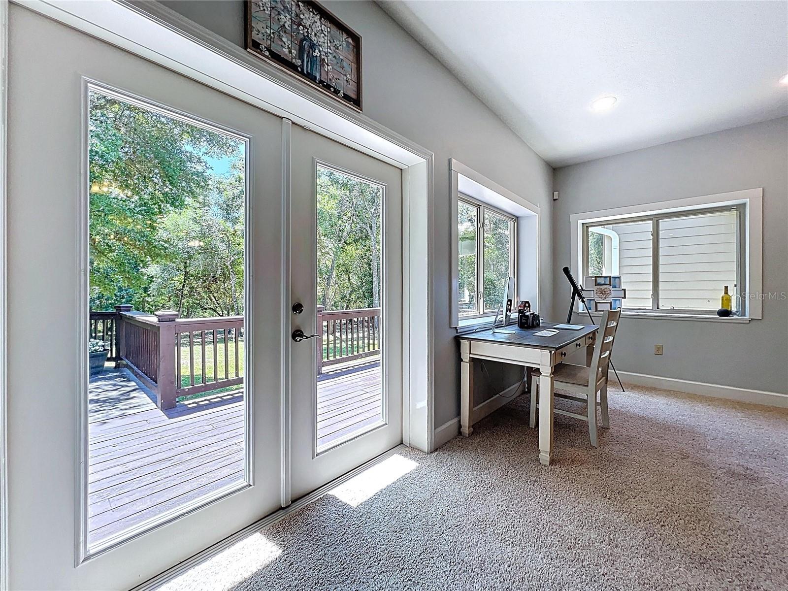 FRENCH DOORS LEAD TO EXPANSIVE DECK