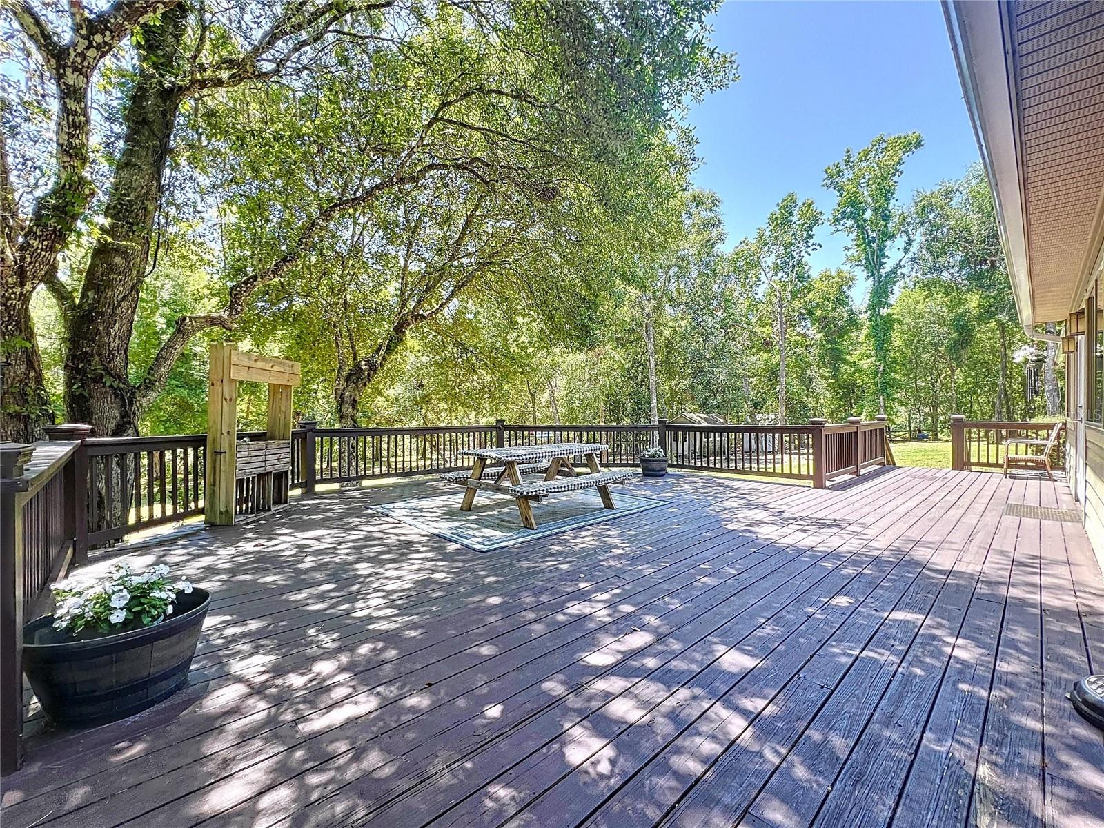 WIDE DECK RUNS ALONG ALMOST ENTIRE LENGHT OF THE HOME