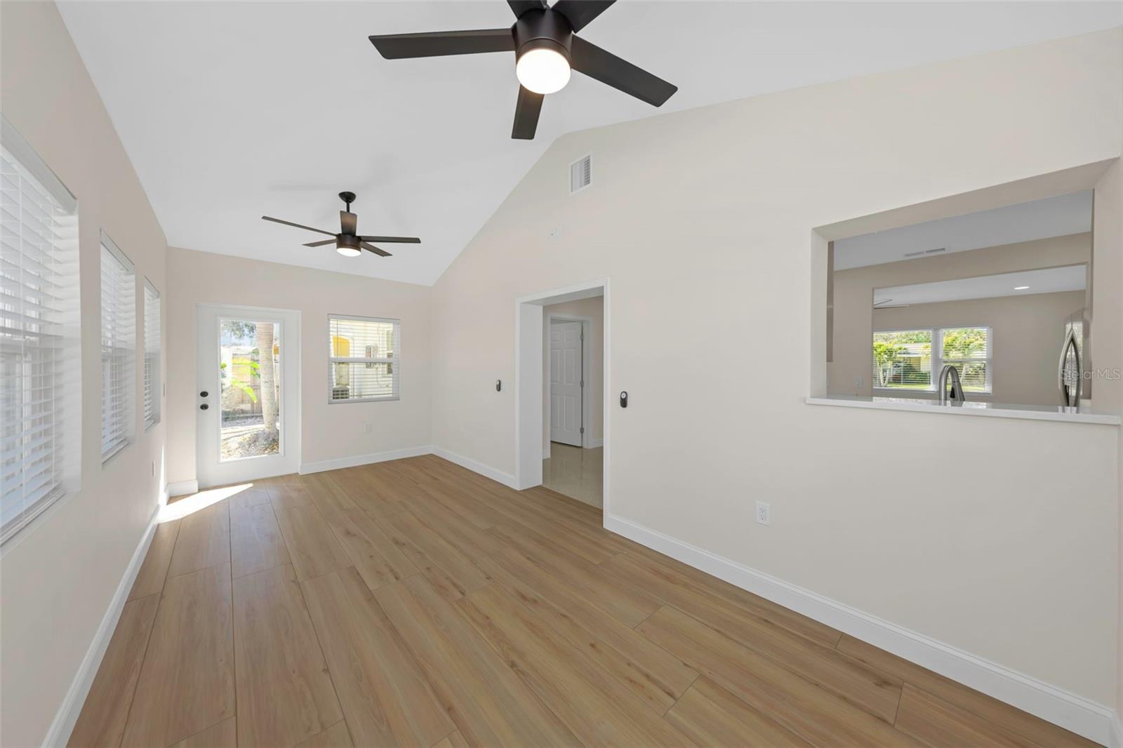 Sizeable Family room includes cathedral ceiling and two french doors out to the open-air pool area.
