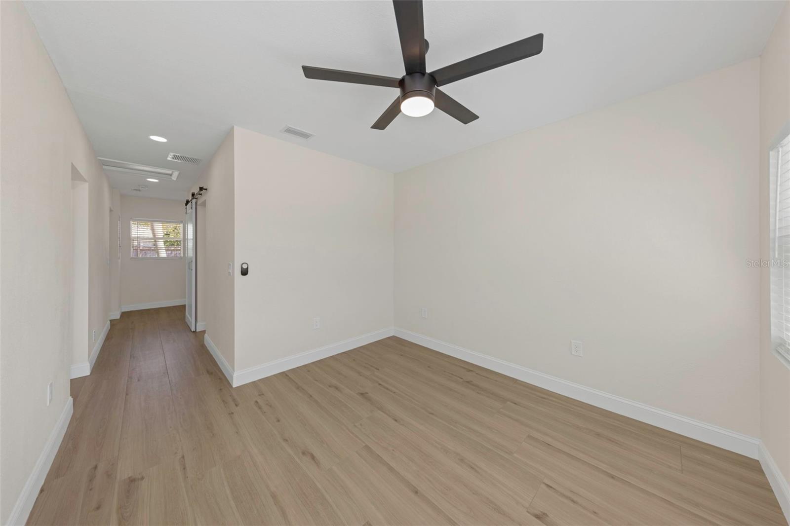 Primary Suite includes wood-like tile flooring, large walk-in closet and fully updated ensuite bathroom.