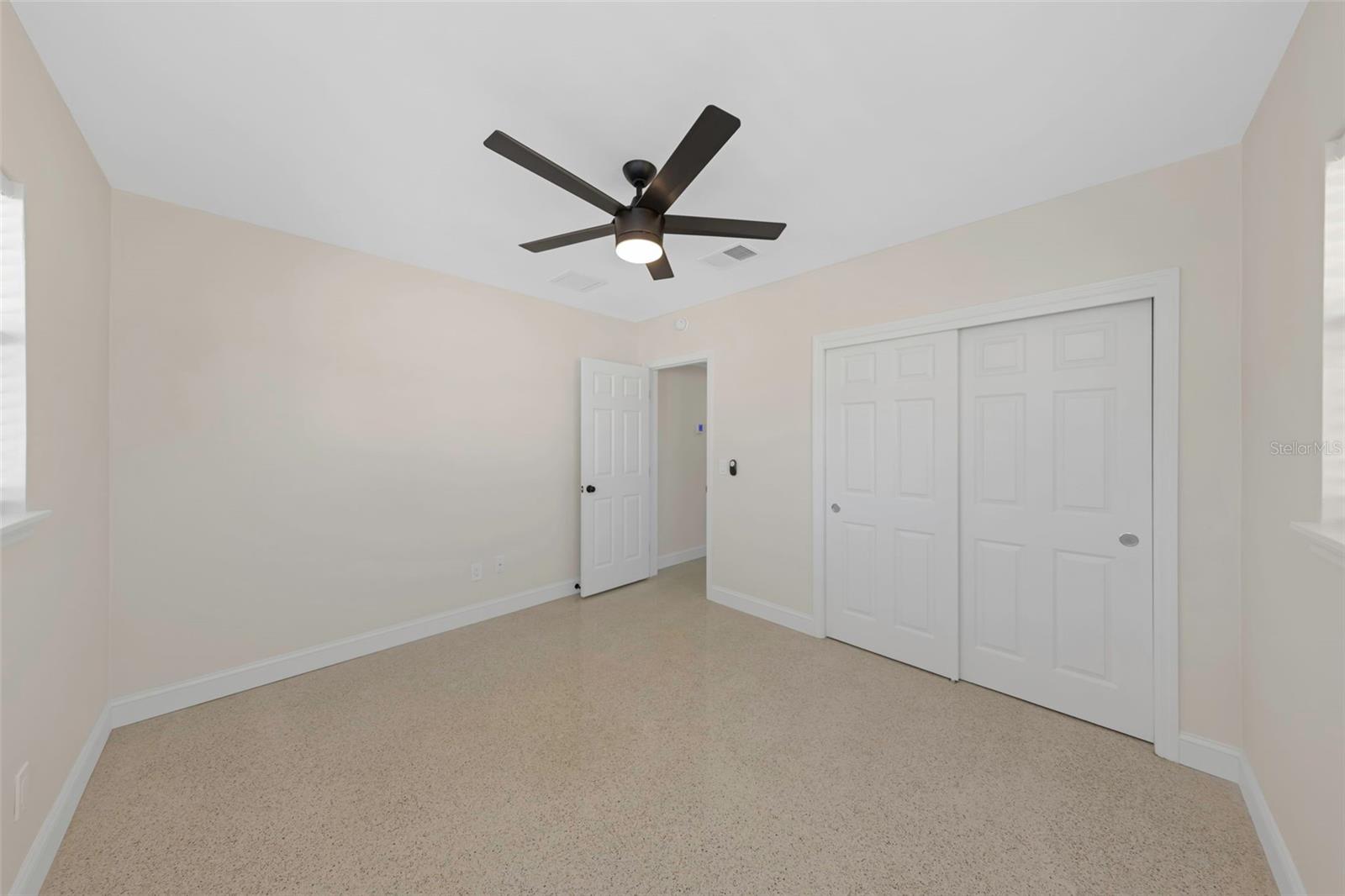 Bedroom 2 with terrazzo flooring and built-in closet.