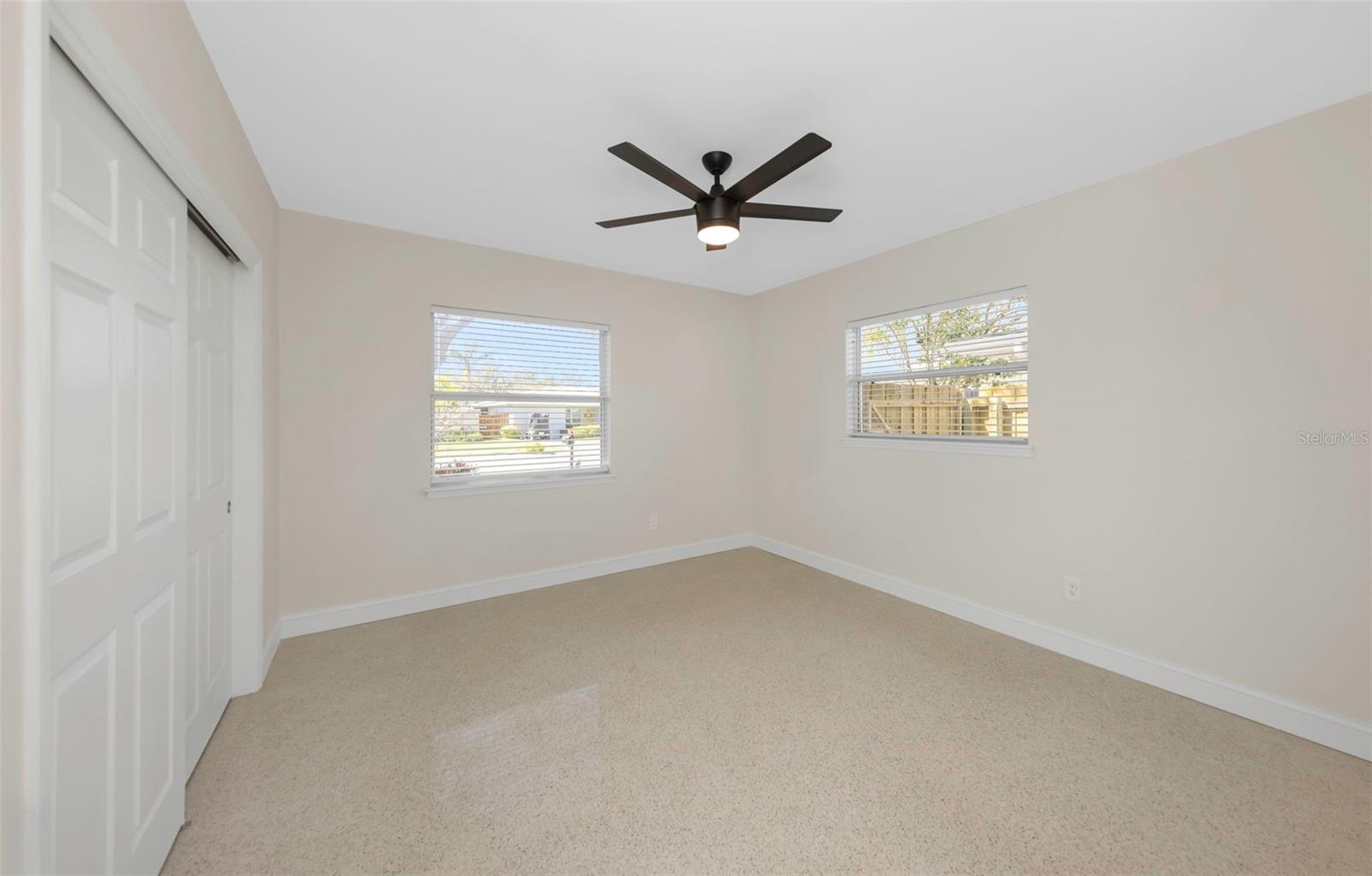 Bedroom 3 with terrazzo flooring and built-in closet.