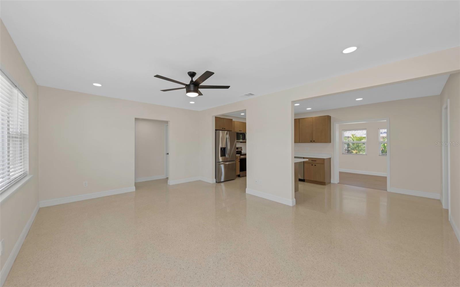 Open floor plan with polished terrazzo flooring throughout most of the living areas.