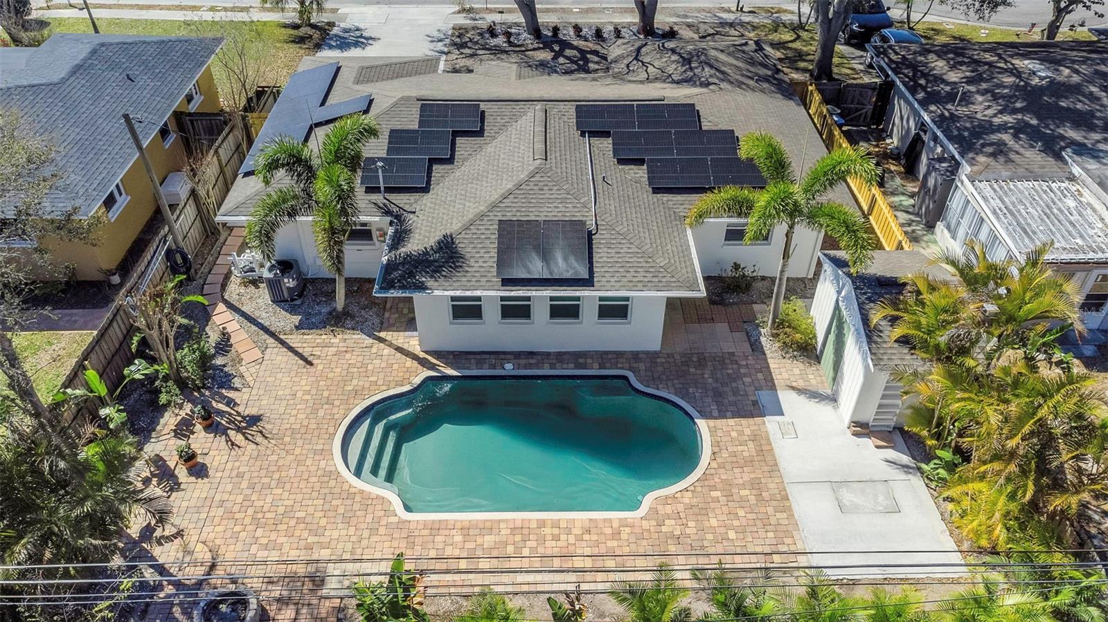 The pool home boasts fully paid for solar panels.