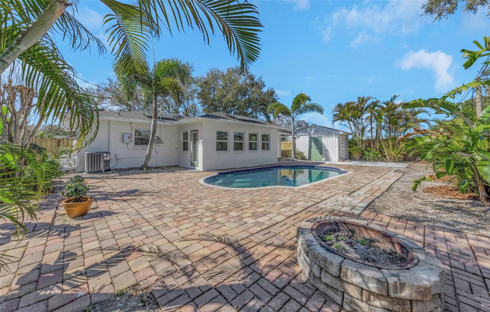 Back yard includes a wood burning firepit.