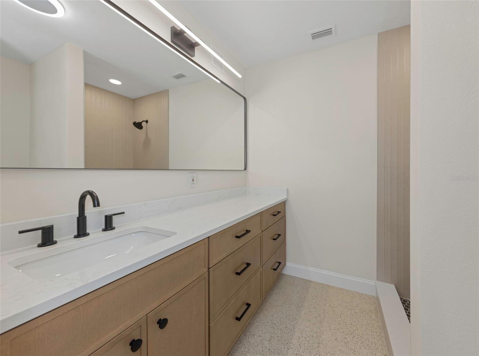 Guest full bathroom with walk-in shower is located off the dining room.