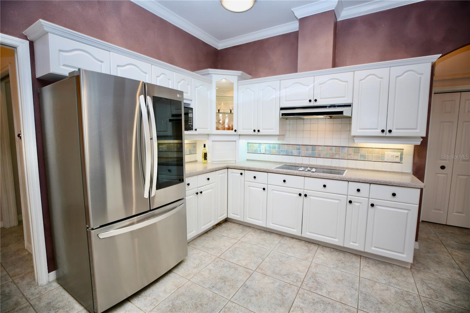 Large kitchen with ample cabinets and lighting