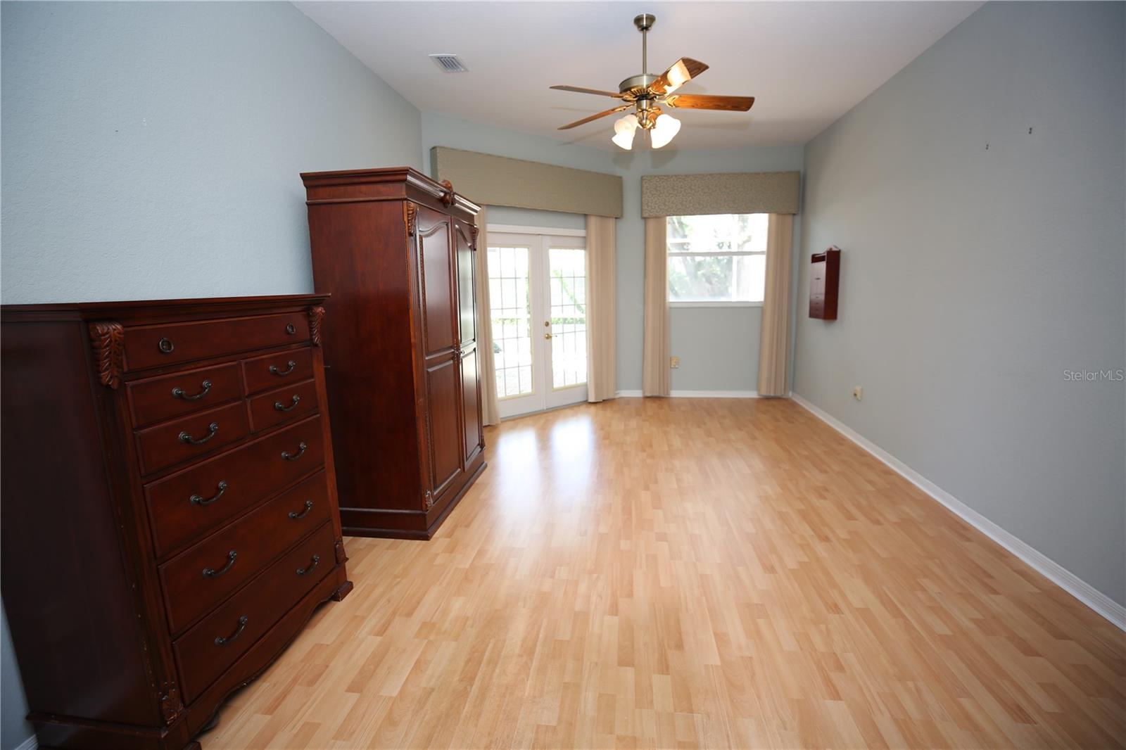 Large Master bedroom suite with french doors open to the patio
