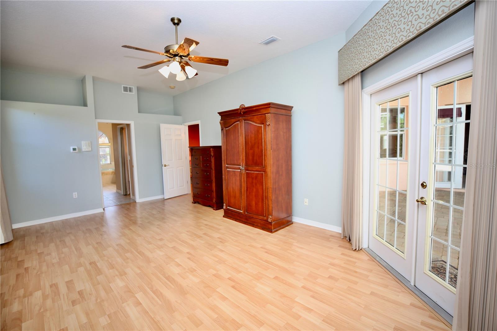 Master Bedroom Suite with high ceilings and wood style floors