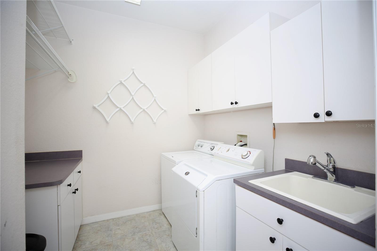 Large Laundry Room with washer and dryer and laundry sink
