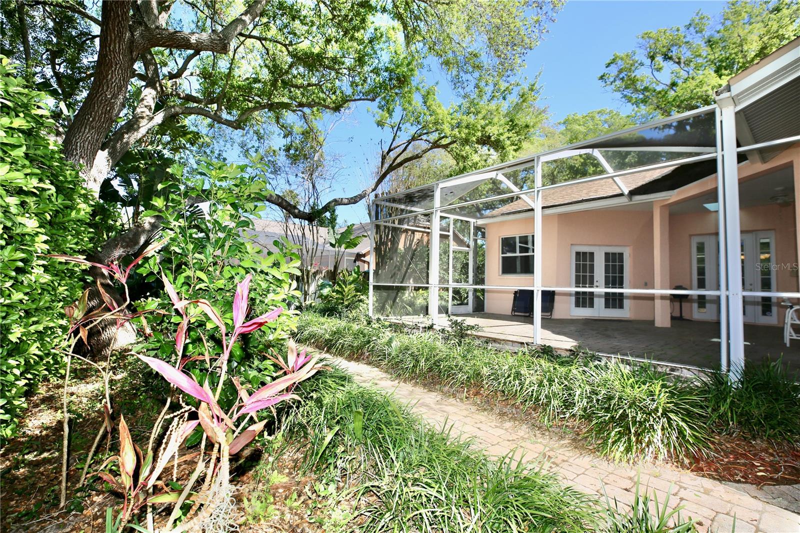 Mature landscaping with brick pathway
