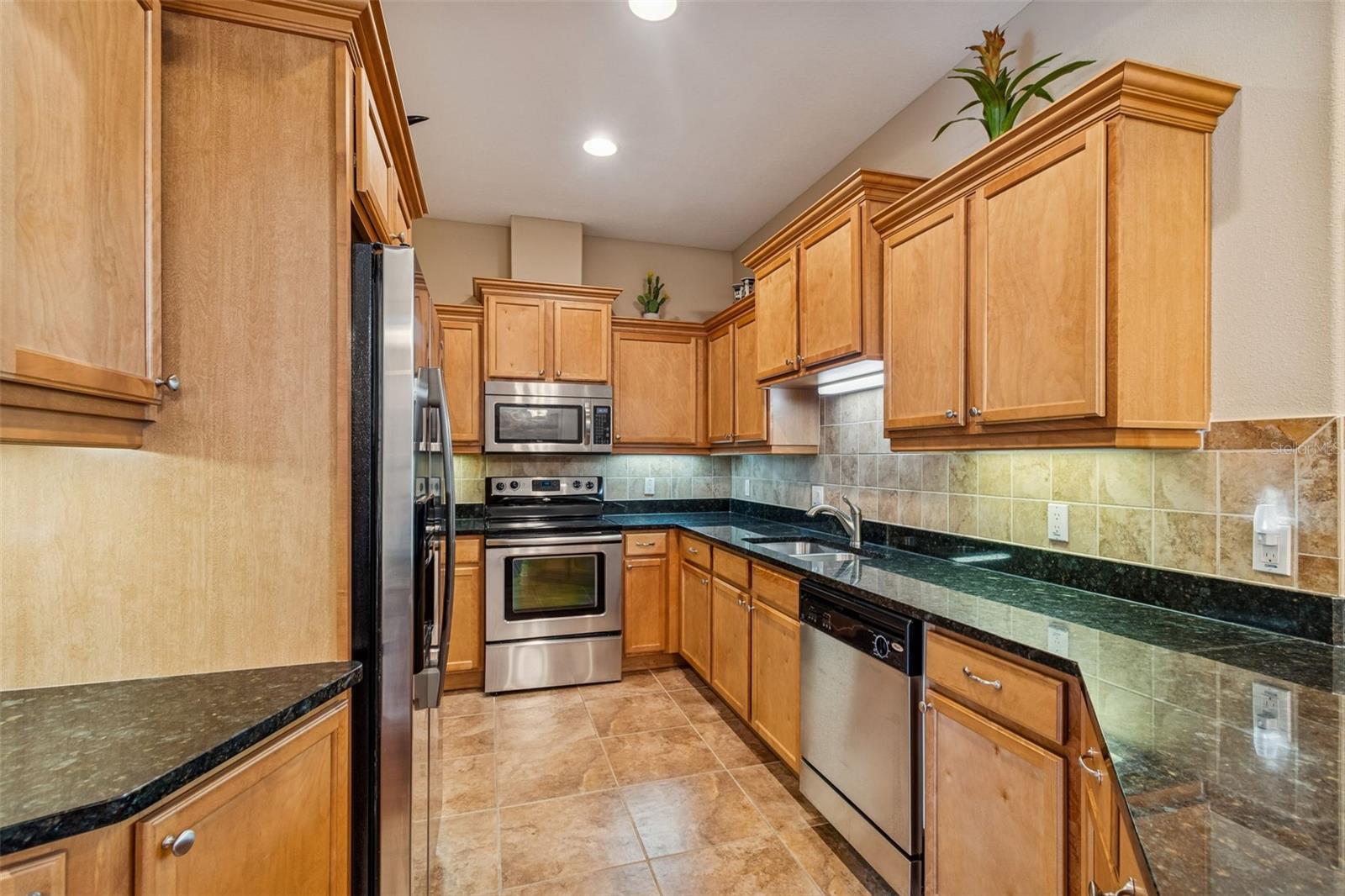 Lovely wood cabinets and ceramic tile floors