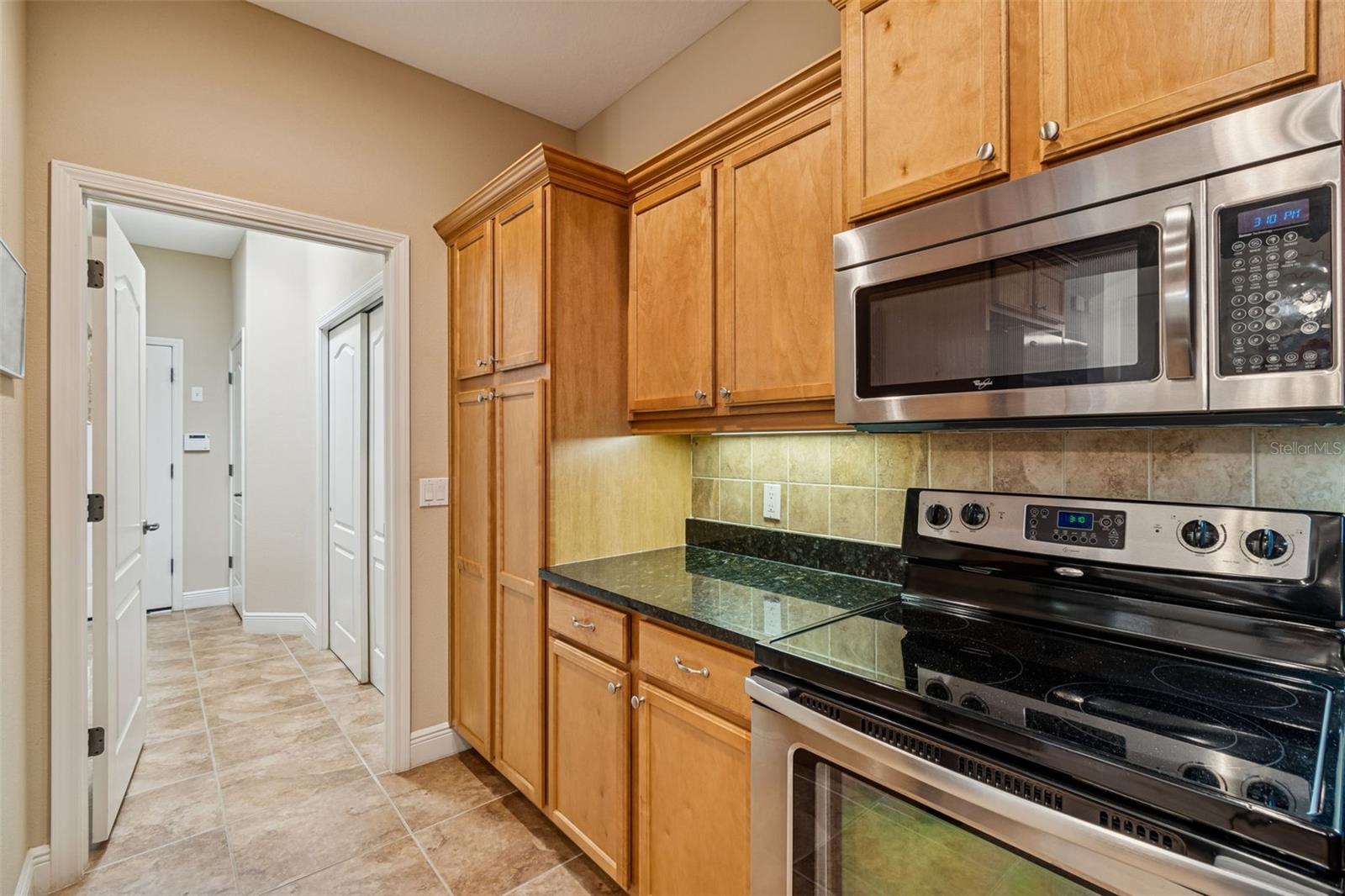 Kitchen wraps around to laundry and garage.
