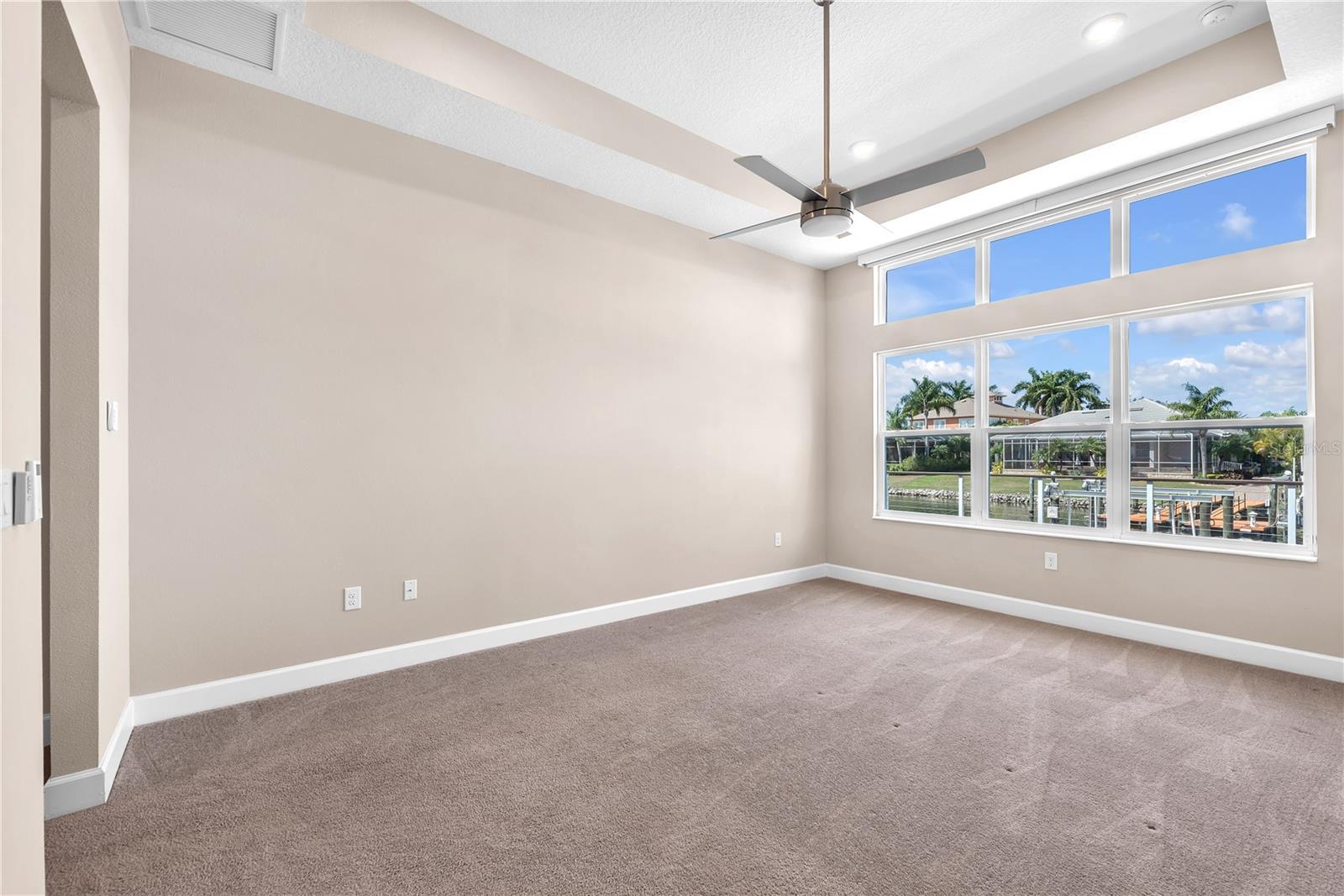 Wake up to canal views in the first-floor primary suite.