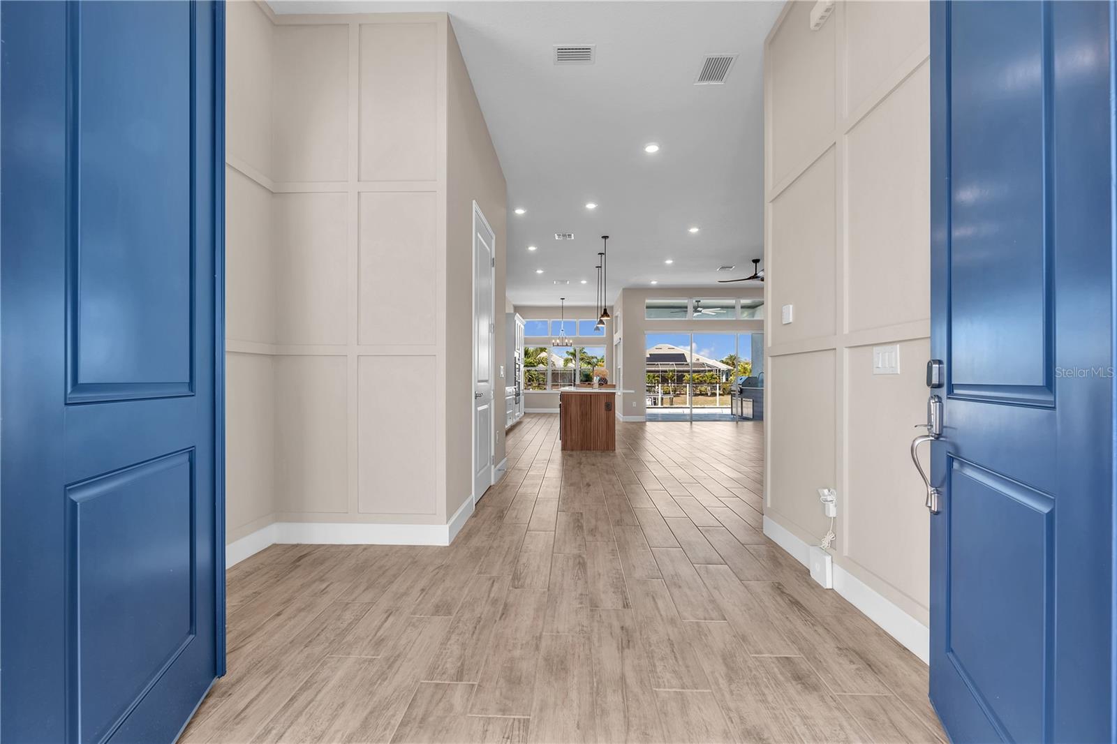 From the moment you step inside, the home welcomes you with light-filled spaces, coastal elegance, and serene water views.