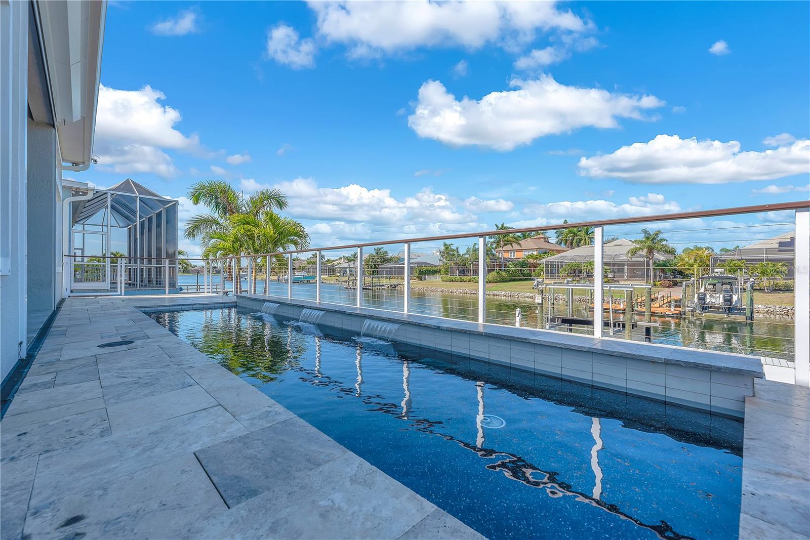 The saltwater pool and inviting waterfalls features invite you to cool off or unwind with an evening swim as the sky turns shades of coral and gold.