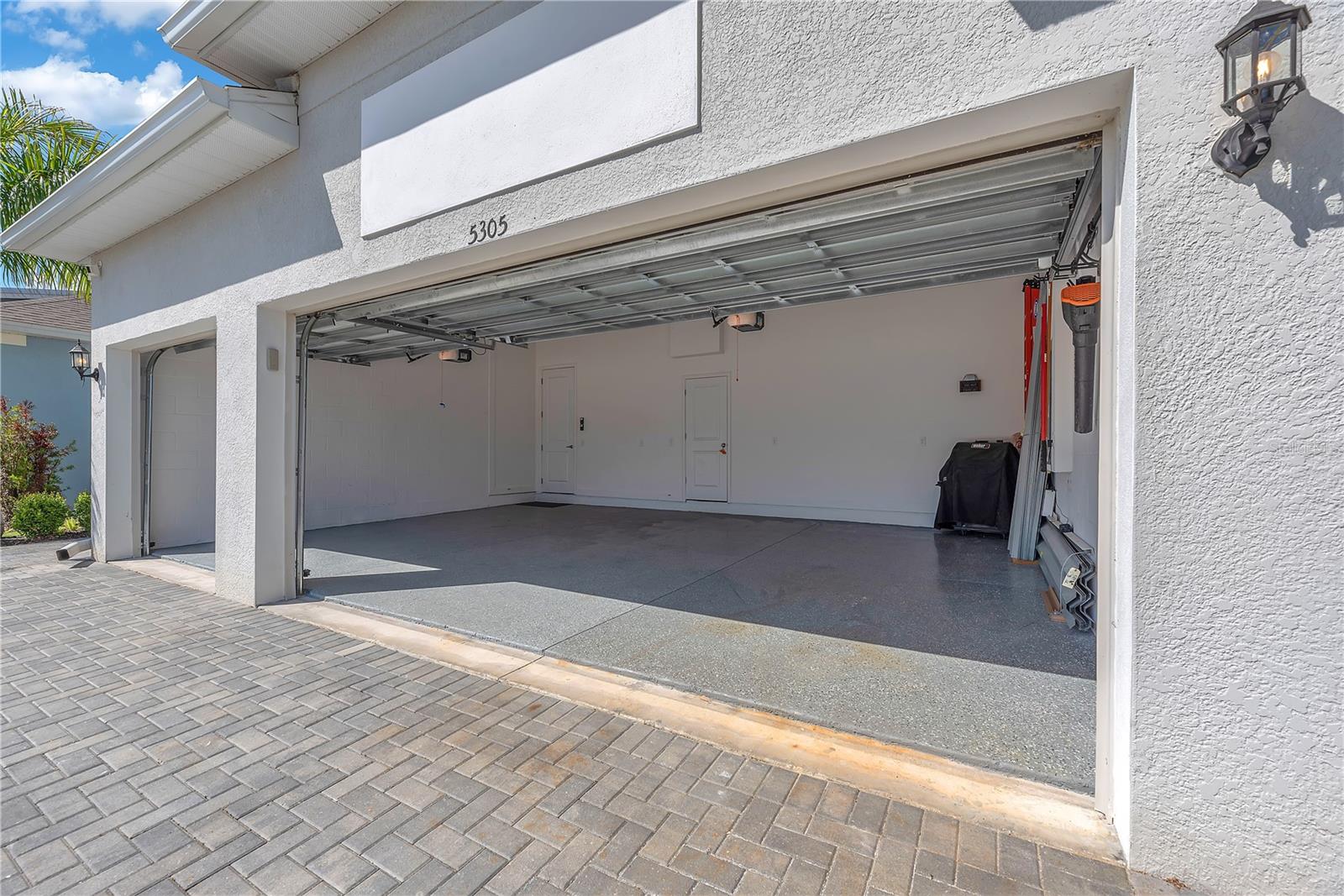 3 car garage is 26.11 X 18.11 and has a separate locked storage closet inside.  Hurricane shutters are stored inside.
