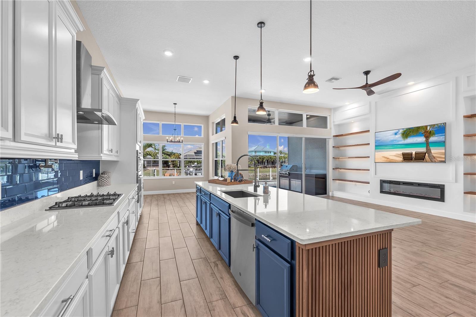The open-concept design is ideal for gatherings and year-round entertaining, seamlessly connecting the gourmet kitchen, dining area, and spacious living room.