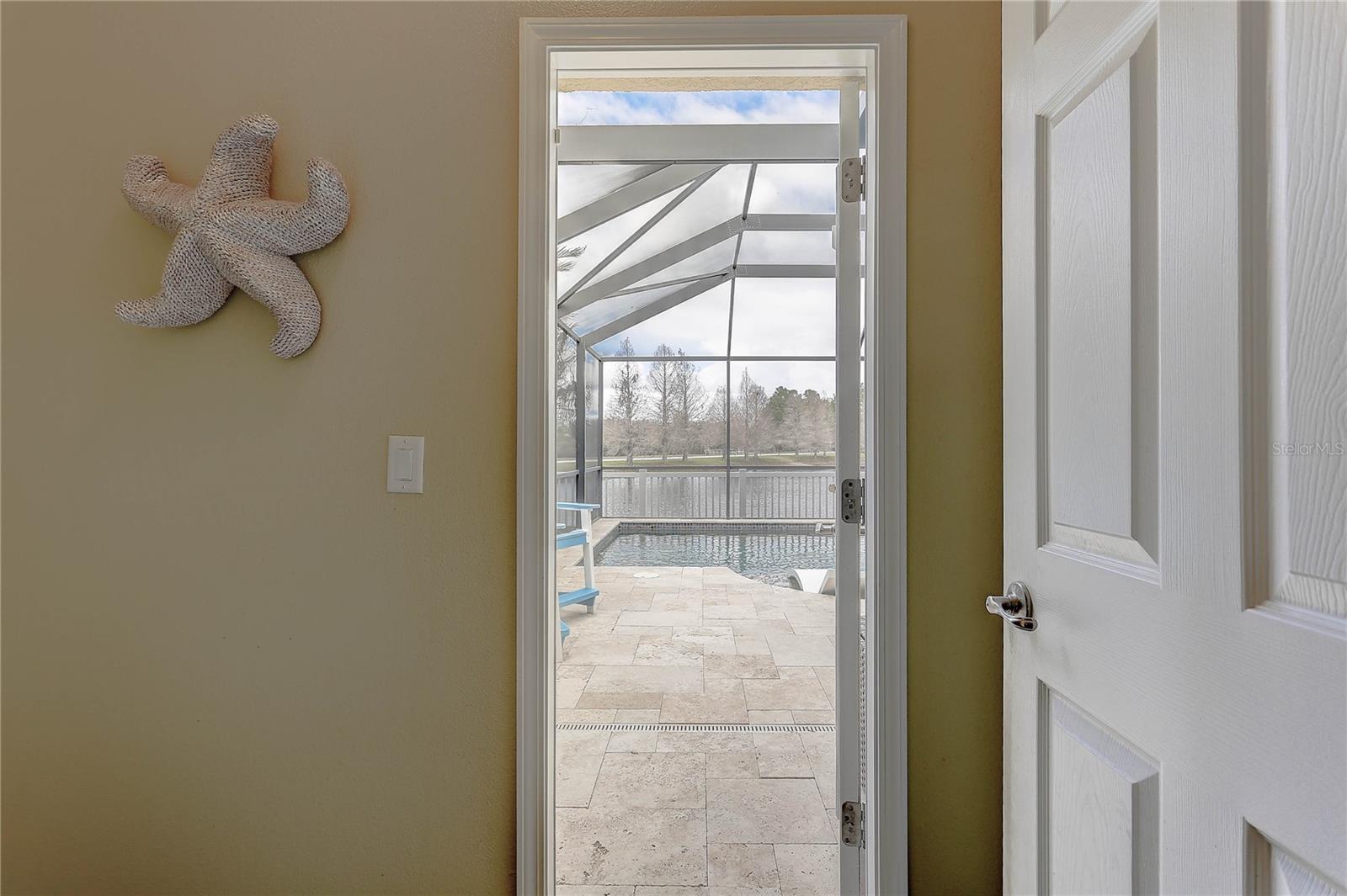 Toilet Room Door Leads to Pool and Outdoor