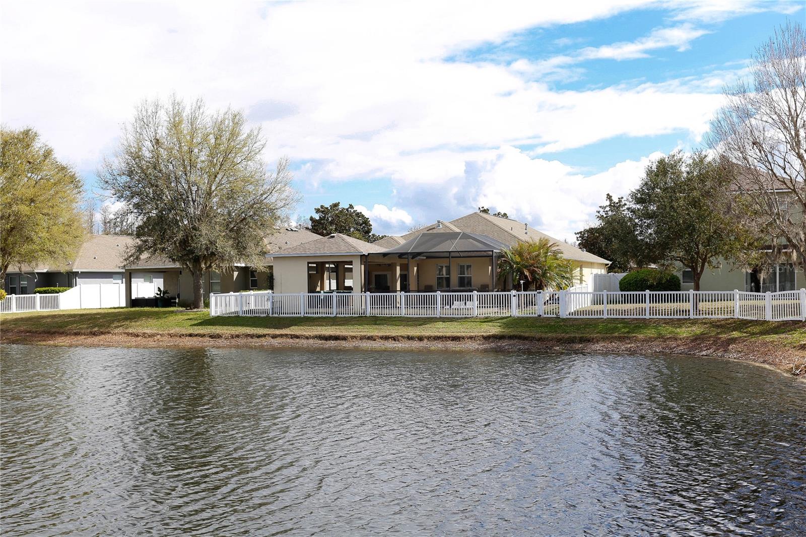 Back of the House, Cabana, Screened Pool, Fenced Yard, Tropically Landscaped, on the Pond.