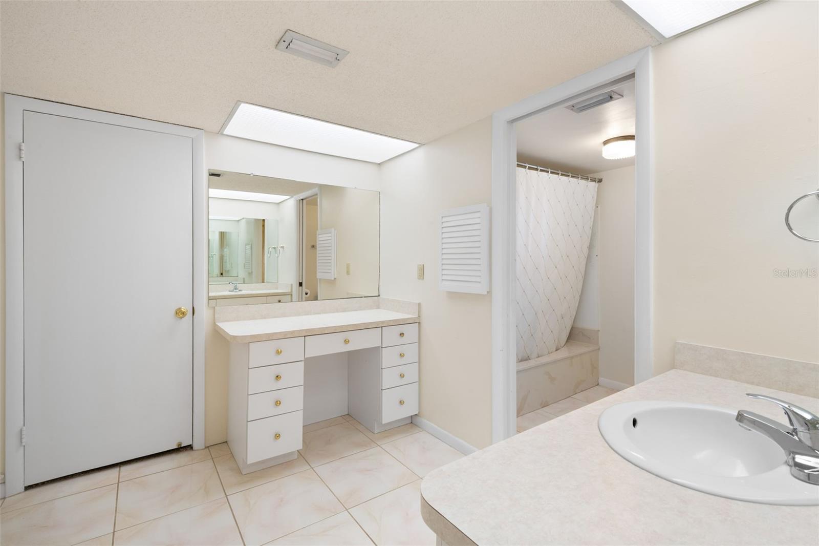 Two Vanities, both with their own drawers and mirrors. Bathtub with shower. Walk-in closet.
