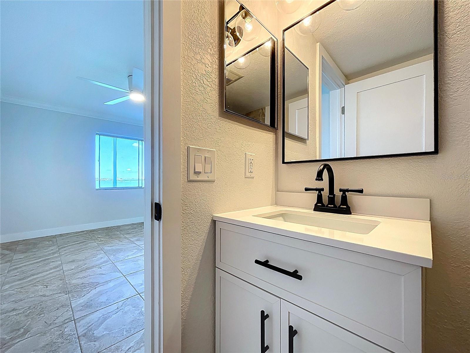 Fully renovated Primary bathroom with walk-in shower and glass shower door.