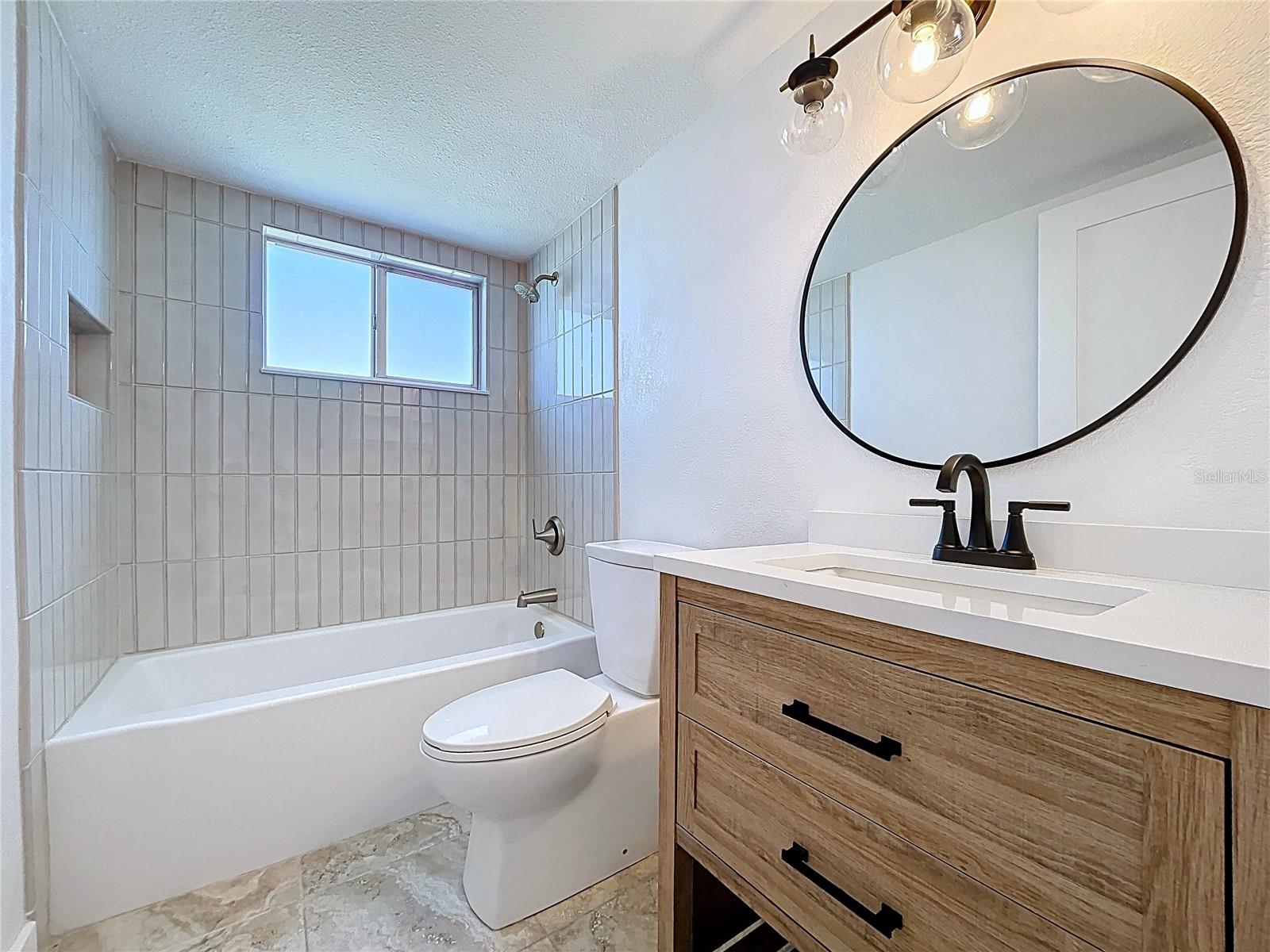 Fully updated guest bathroom with tun and new vanity.