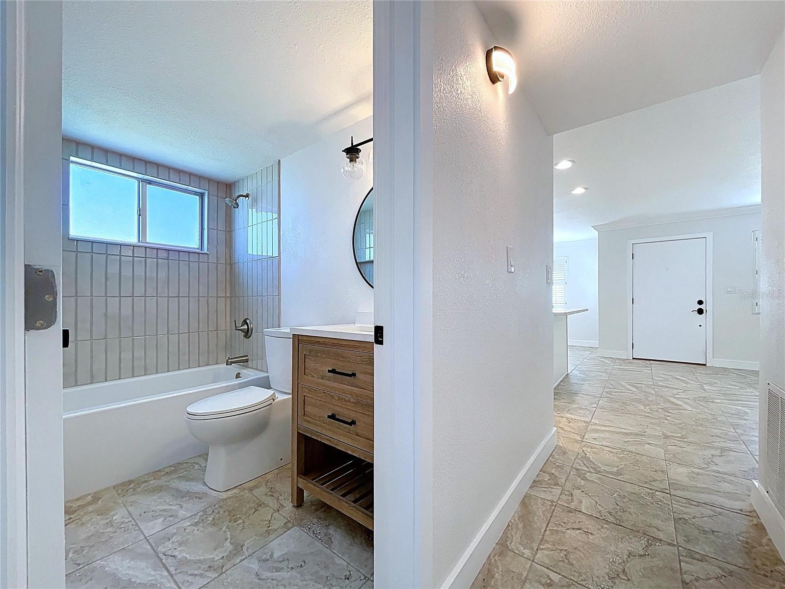 Fully updated guest bathroom with tun and new vanity.
