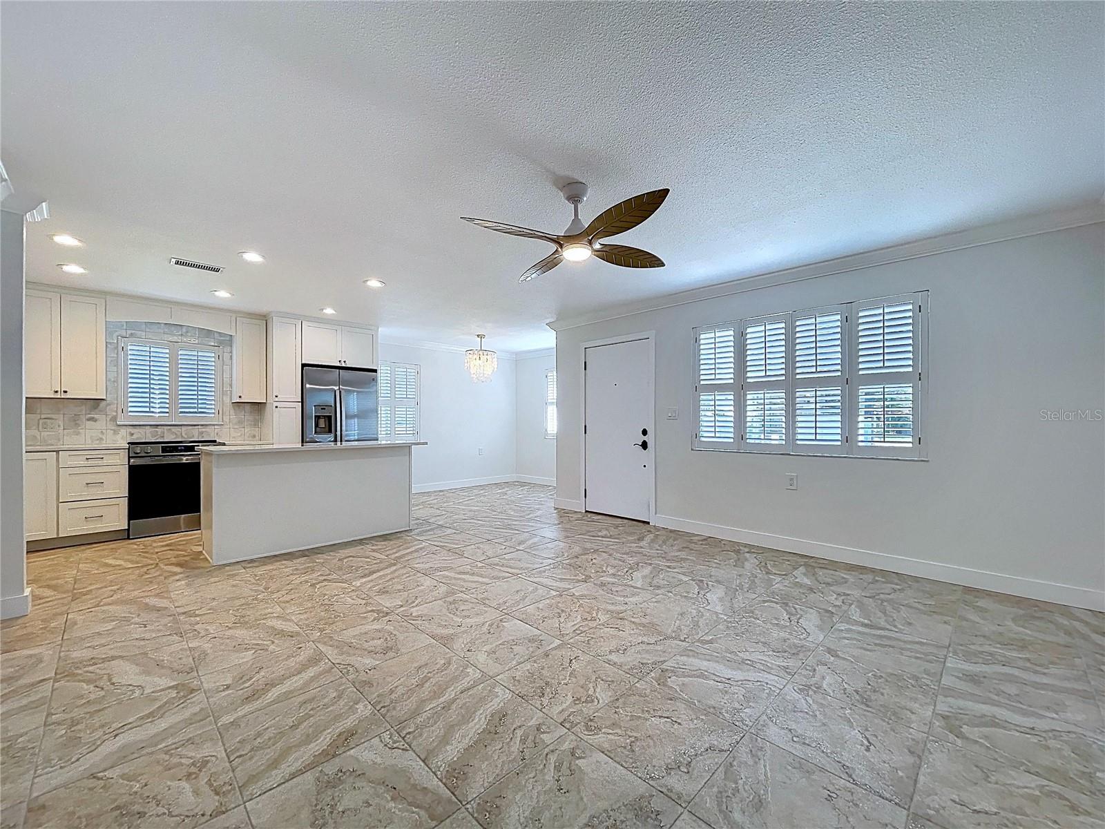 Open living space combines the living room, kitchen and dining room.