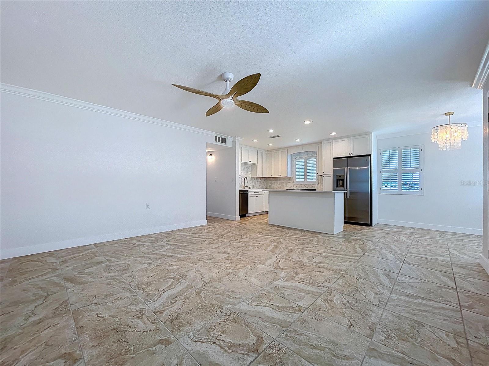 Open living space combines the living room, kitchen and dining room.