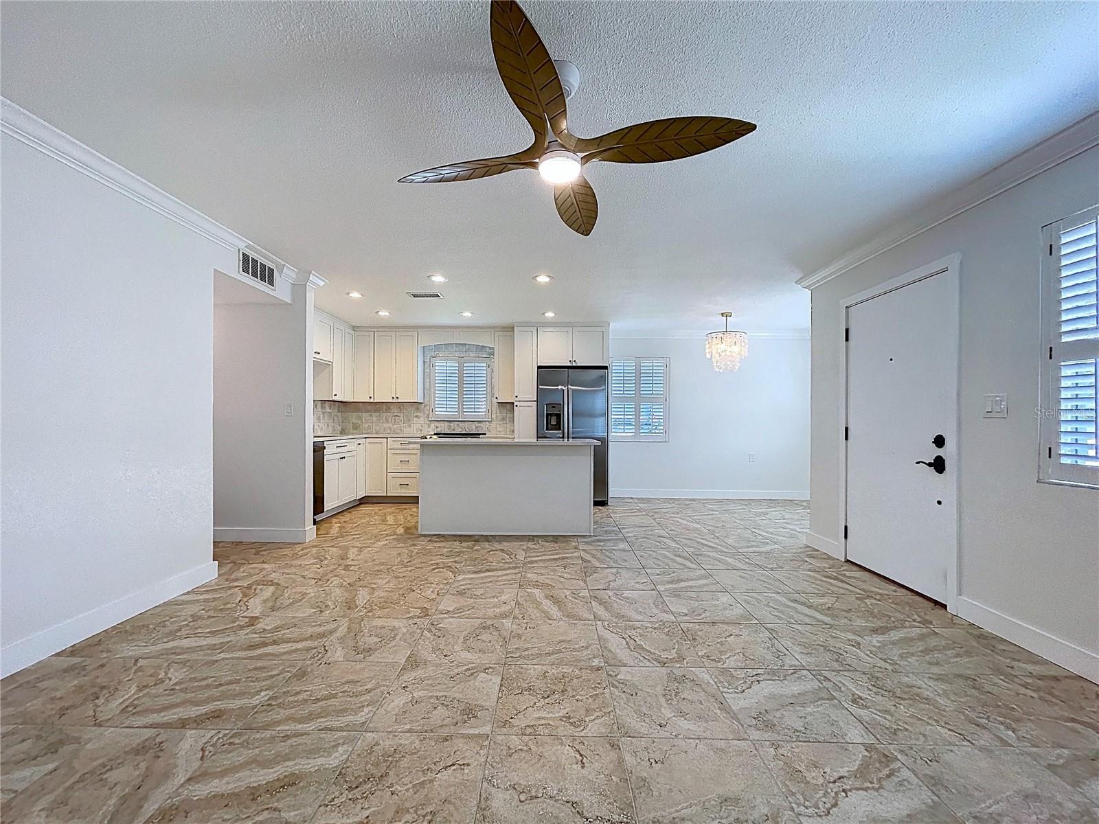 Open living space combines the living room, kitchen and dining room.