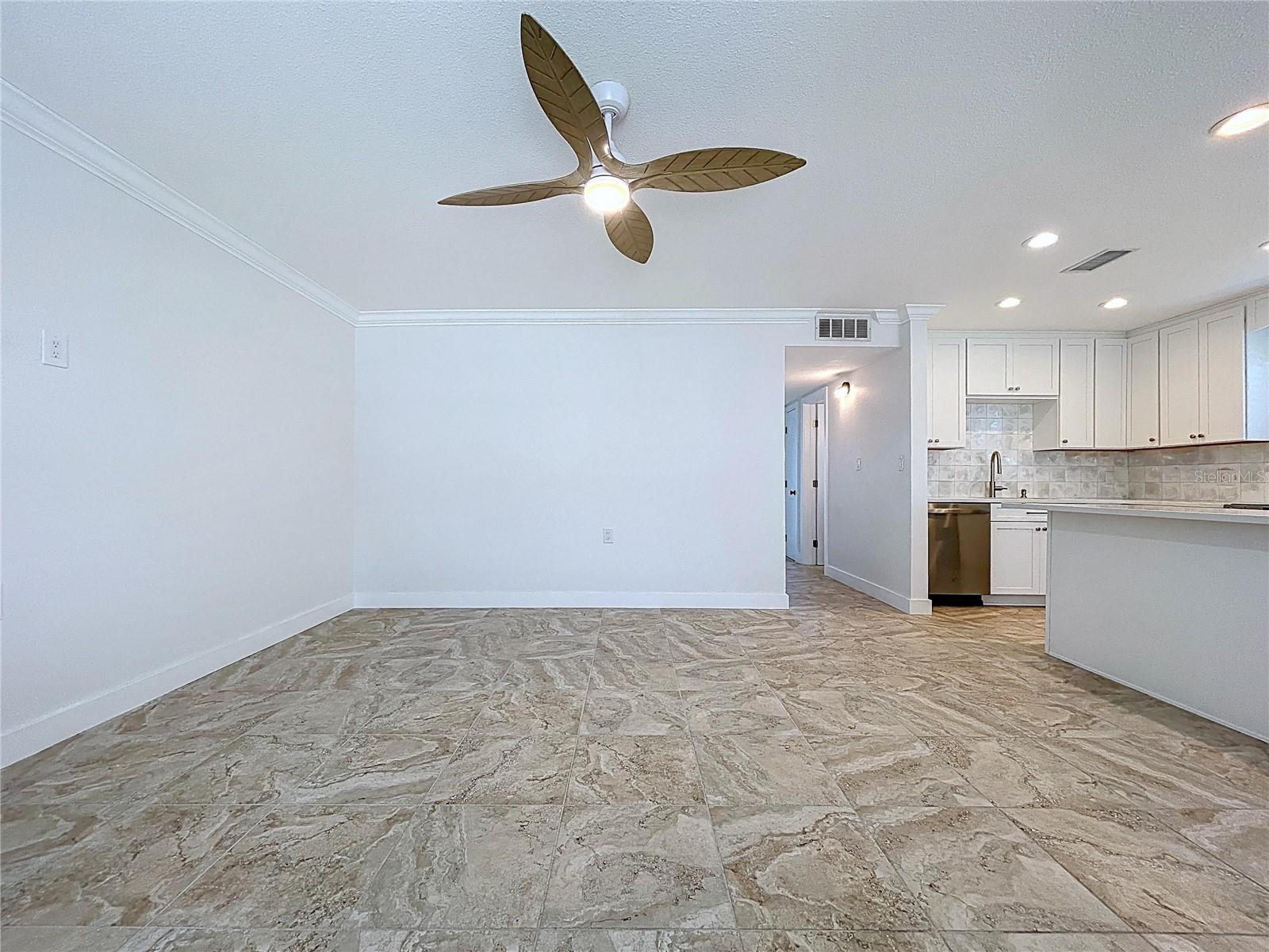 Open living space combines the living room, kitchen and dining room.