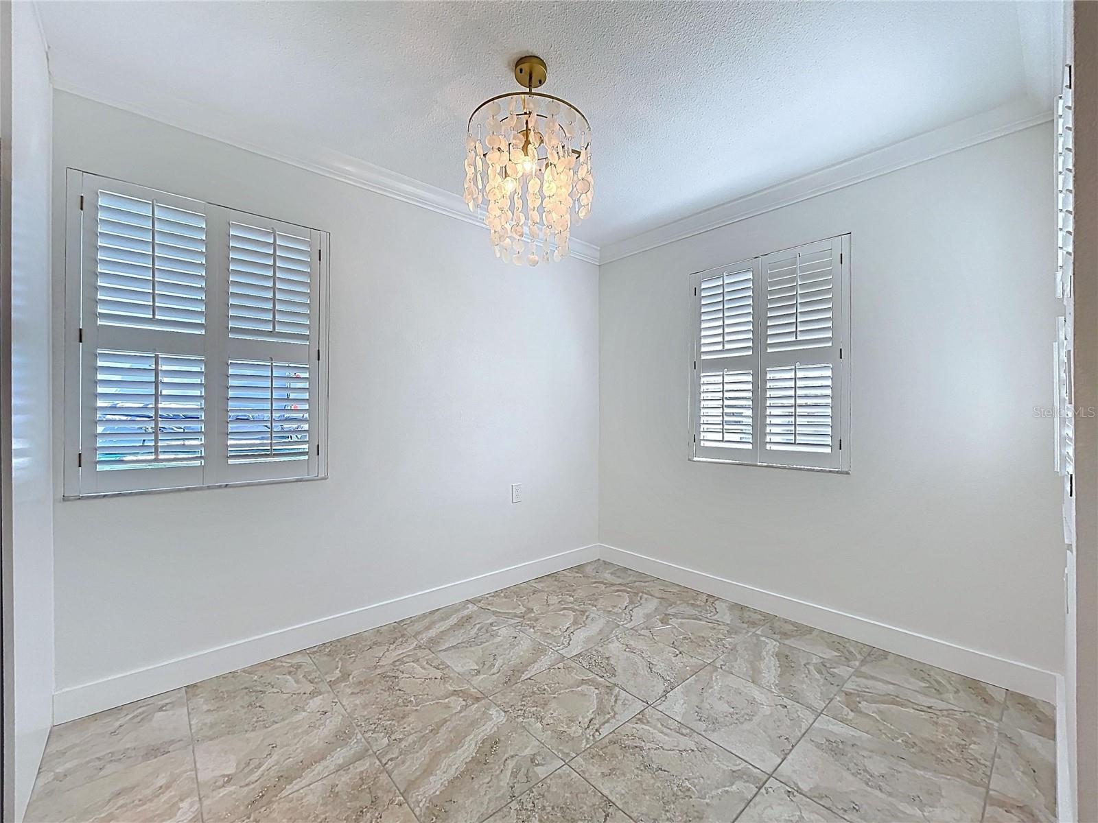 The dining room offers three bright windows thanks to the position of this corner unit condo.