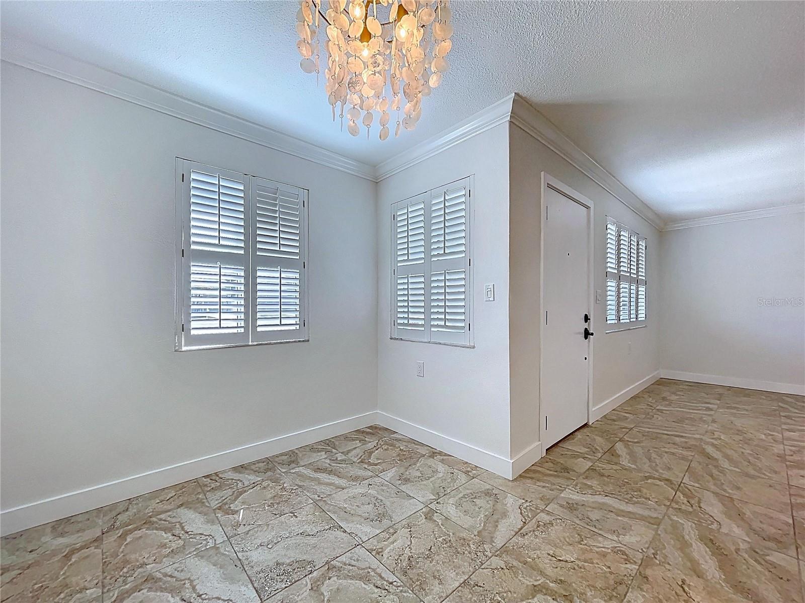 The dining room offers three bright windows thanks to the position of this corner unit condo.