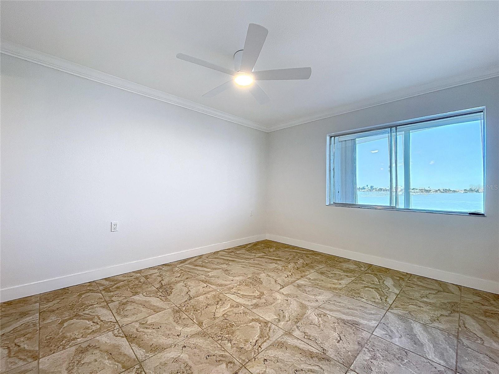 The Primary bedroom offers views of the waterways of John's Pass.